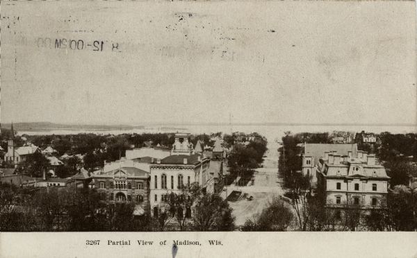 Elevated view down Wisconsin Avenue from the Square. Madison City Hall is on the left. Lake Mendota is in the distance. Caption reads: "Partial View of Madison, Wis."