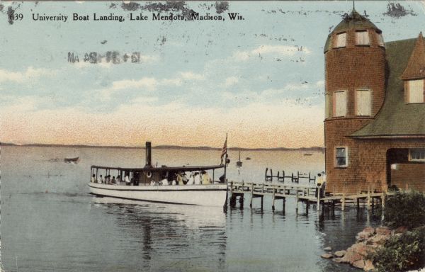 View from shoreline towards the Steamer "Wisconsin" docked at the pier of the University boat landing on Lake Mendota.