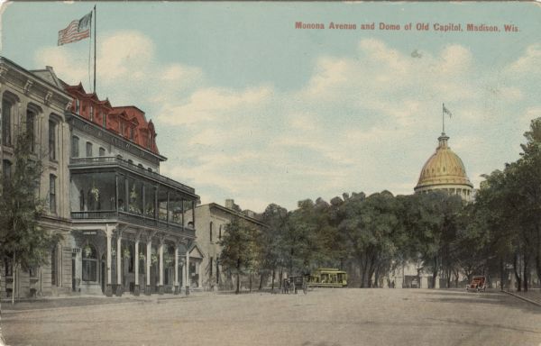 View up Monona Avenue towards the first Capitol dome. A hotel is on the left, and a streetcar is at the intersection. Caption reads: "Monona Avenue and Dome of Old Capitol, Madison, Wis."