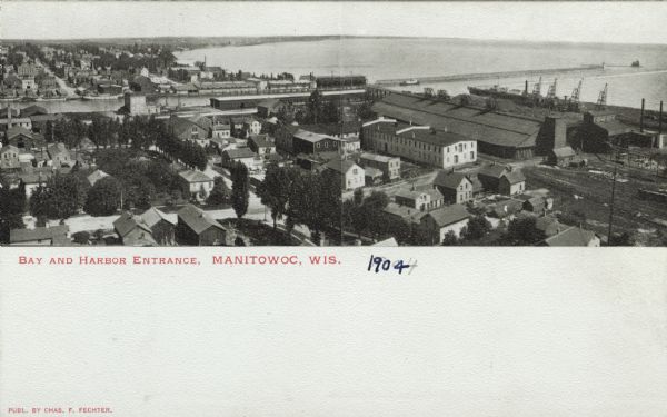 Elevated view of Manitowoc and Lake Michigan. Caption reads: "Bay and Harbor Entrance, Manitowoc, Wis."