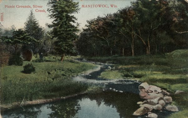 View of a stream going through a park. Caption reads: "Picnic Grounds, Silver Creek, Manitowoc, Wis."