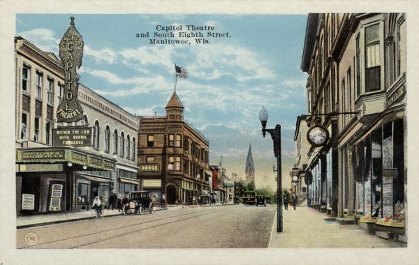 View across street toward the Capitol Theatre on the left side of the street, with a marquee that reads: "Within the Law" starring Norma Talmadge. Caption reads: "Capitol Theatre and South Eighth Street, Manitowoc, Wis."
