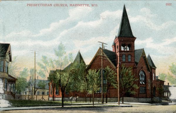 View down street toward a church on a street corner. Caption reads: "Presbyterian Church, Marinette, Wis."