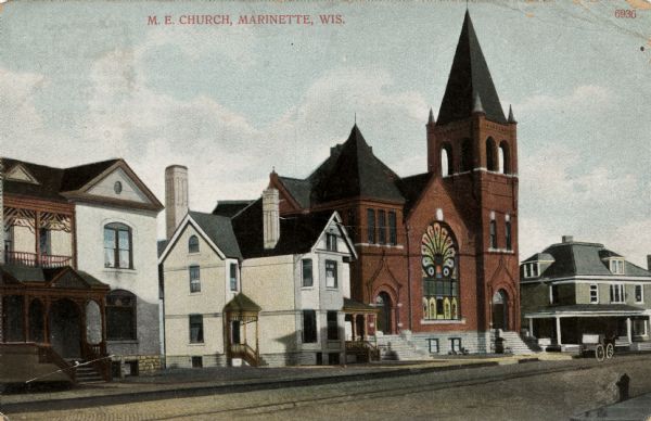 Exterior view of the church in a residential neighborhood. Caption reads: "M.E. Church, Marinette, Wis."