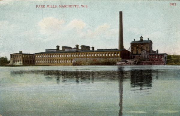 View across water towards a mill on the waterfront. Caption reads: "Park Mills, Marinette, Wis."