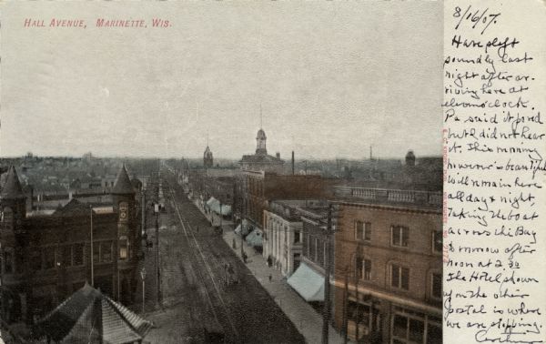 Elevated view of a street in a central business district. Caption reads: "Hall Avenue, Marinette, Wis."