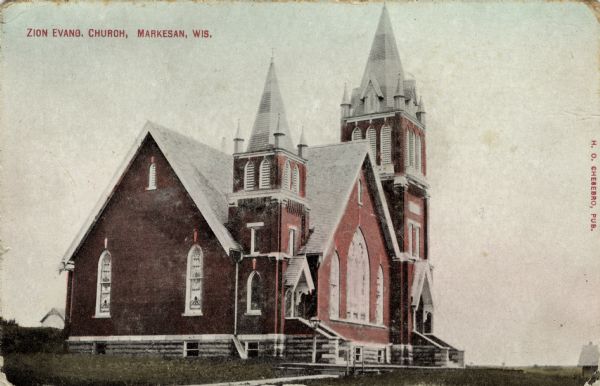 Exterior view of a church with two steeples. Caption reads: "Zion Evang. Church, Markesan, Wis."