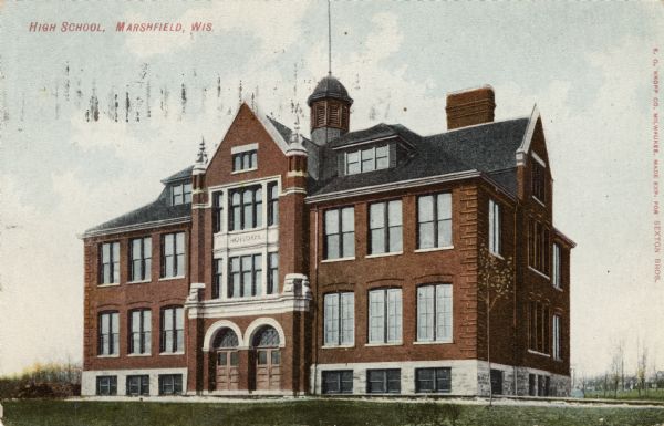 Exterior view of a brick high school with a bell tower. Caption reads: "High School, Marshfield, Wis."