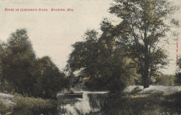 View down river towards a man in a rowboat. Caption reads: "Scene on Lemonweir River, Mauston, Wis."