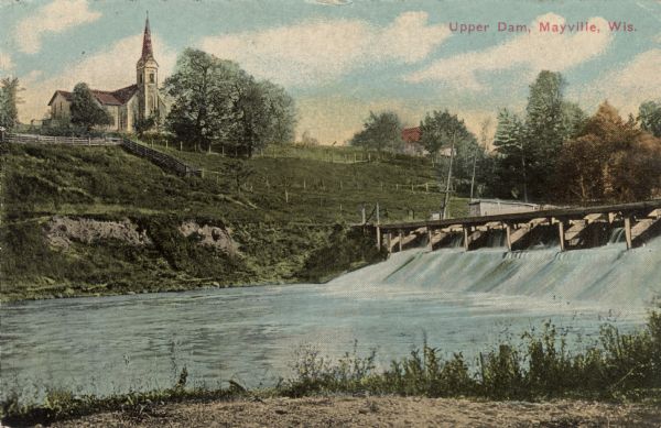 View of the Upper Dam on the Rock River near Mayville. A church is on the hill on the left. Caption reads: "Upper Dam, Mayville, Wis."