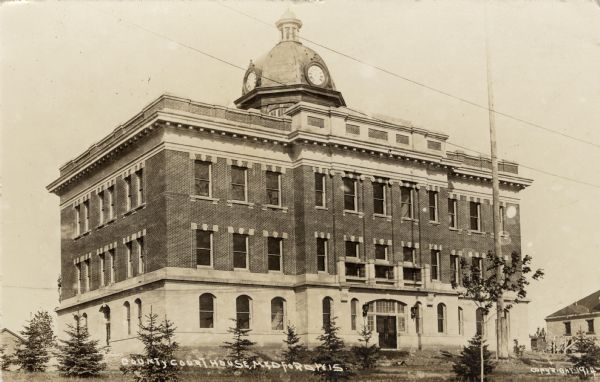 Exterior view of the Taylor Courthouse featuring a cupola with clocks. Caption reads: "County Courthouse, Medford, Wis."