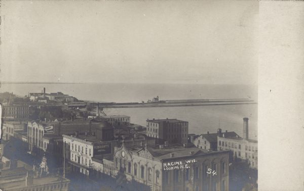 Text on front: "Racine, Wis. Looking N.E." Elevated view of the city and harbor, looking Northeast.