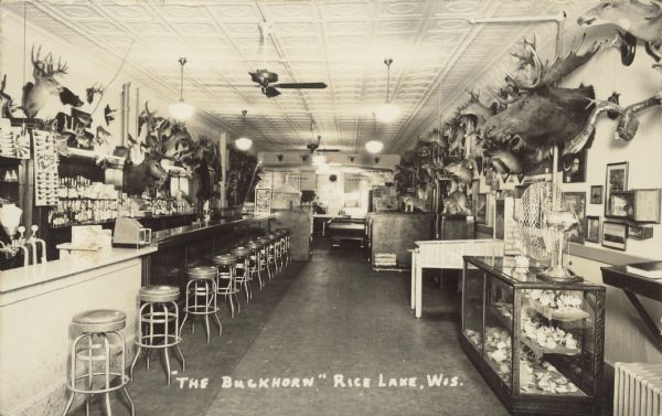 Text on front reads: "'The Buckhorn,' Rice Lake, Wis." The Buckhorn Tavern had an amazing display of taxidermy and curios, including some hoaxes: a shovel-tailed snowsnake, a dingbat and a fur herring. Originally the Buckhorn was a billiard parlor.