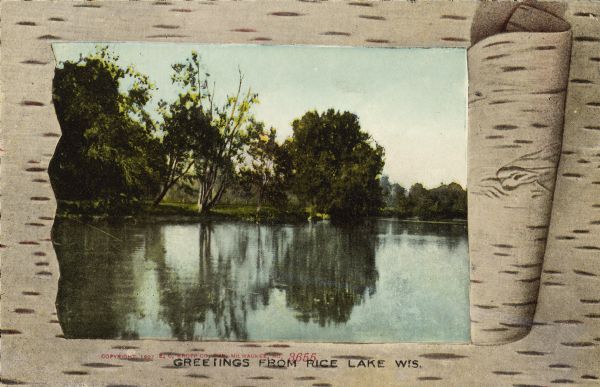 Text on front reads: "Greetings from Rice Lake Wis." printed over red text that reads: "Copyright 1927, E.C. Kropp Company, Milwaukee, Wis." The view of Rice Lake is framed by birch bark with the center portion rolled to the right. The scene shows a still lake with reflections of the trees along the shoreline.