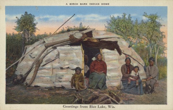 Text on front reads: "A Birch Bark Indian Home, Greetings from Rice Lake, Wis." A Native American family of five is seated in front of their birch bark wigwam. Trees are in the background.