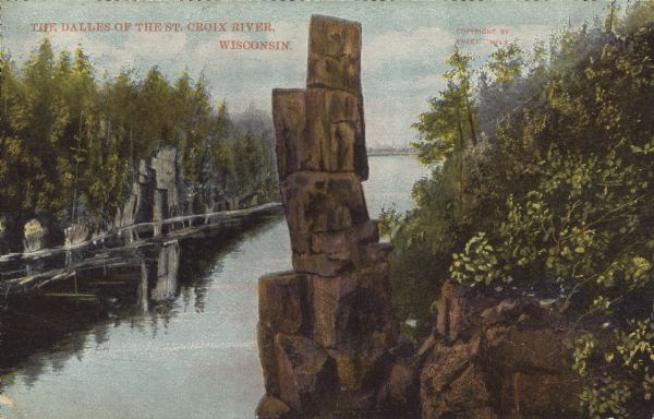 Text on front reads: "The Dalles of the St. Croix River, Wisconsin." Elevated view of the St. Croix River showing the rock formation "Devil's Chair" in the center. Text on the reverse: "DEVIL'S CHAIR-One of the most picturesque of the famous Dalles of the St. Croix. Through the action of water in bygone ages, the rocks were fashioned into the shape of a gigantic chair. Why it should be assigned to the devil is past understanding, for nothing in the beautiful surroundings suggest the infernal regions."