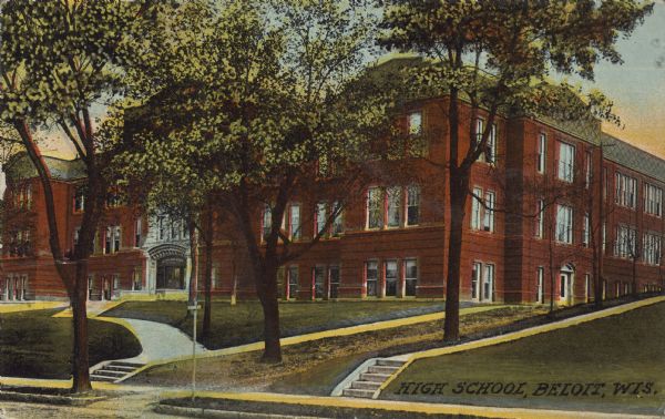 Text on front reads: "High School, Beloit, Wis." A three-story, brick building with stone ornamentation, surrounded by sidewalks and trees.