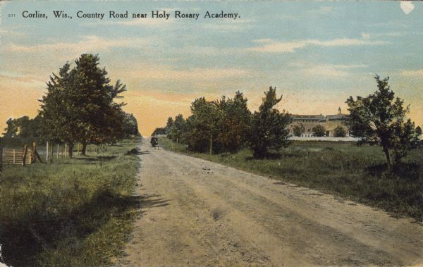 Text on front reads: "Corliss, Wis., County Road Near Holy Rosary Academy." A horse drawn buggy drives along an unpaved road. On the right is the Holy Rosary Academy and on the left is a fenced area with a wooden gate. Trees can be seen throughout.