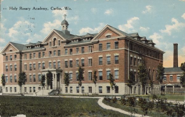 Text on front reads: "Holy Rosary Academy, Corliss, Wis." A large, brick, boarding school opened by the Racine Dominican Sisters. It is four stories with a lower level, has many windows and a belfry.