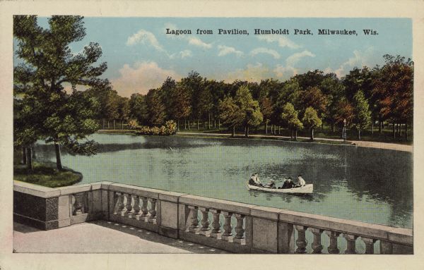 Text on front reads: "Lagoon from Pavilion, Humboldt Park, Milwaukee, Wis." View of the water from a terrace with a stone balustrade. Several people are in a rowboat. The far shore has a sidewalk lined with trees.