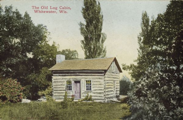 Text on front reads: "The Old Log Cabin, Whitewater, Wis." The log cabin was built in 1846 by Norwegian immigrants Gullik Halverson and his wife, Dorothea. It is built of hand-hewn timbers and has a sandstone foundation. It was moved to the UW-Whitewater campus in 1907. It is listed on the State and National Register of Historic Places.
