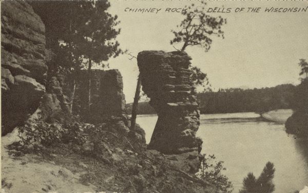 Text on front reads: "Chimney Rock, Dells of the Wisconsin." The rock formation Chimney Rock overhanging the Wisconsin River. Bluffs are on the left and the river is on the right.
