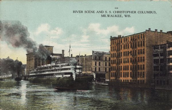 Text on front reads: "River Scene and S.S. Christopher Columbus, Milwaukee, Wis." The only whaleback ship ever built for passenger service is moored at the "Smith, Thorndike and Brown, Grocers" building, on the Milwaukee River. A tugboat is in front and more boats are in the distance, all billowing steam and smoke. Commercial buildings line the shoreline of the river. Some signs read: "Bradley & Metcalf Co. Shoemakers," "Ship Chandlers, Awnings, Tents."
