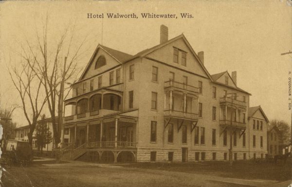 Text on front reads: "Hotel Walworth, Whitewater, Wis." A multistory hotel with a raised porch and many balconies.