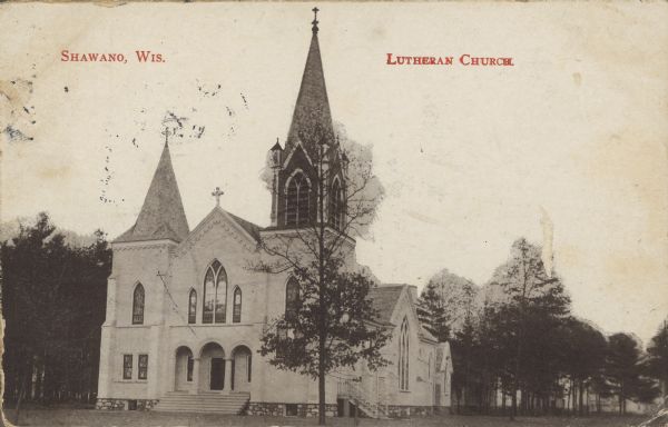 Text on front reads: "Shawano, Wis. Lutheran Church." The St. Jakobi Luthern Church with an ornate steeple and trees.