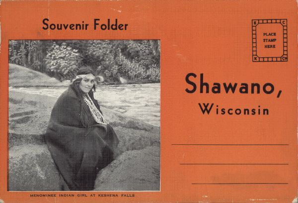 Text on front reads: "Souvenir Folder,  Menominee Indian Girl at Keshena Falls, Shawano, Wisconsin." She is sitting on a rock, posing in a blanket and indigenous jewelry. A souvenir folder containing an accordion folded group of 18 postcard images. 1. A View at the County Park Beach. 2. The Golf Club. 3. Menominee Indian Beauty at Keshena Falls. 4. Spirit Rock, Menominee Indian Reservation. 5. Shooting the Rapids at Keshena Falls. 6. Big Eddy on Wolf River, Menominee Indian Reservation. 7. Pine Row, Menominee Indian Reservation. 8. Bear Trap Falls, Menominee Indian Reservation. 9. Menominee Indian Chief. 10. Little Smoky Falls, Menominee Indian Reservation. 11. Menominee Indian Reservation Mills at Neopit. 12. Keshena Falls. 13. Municipal Hospital. 14. The Dells, North of Shawano. 15. Wolf River Rapids. 16. An Indian Burying Ground. 17. Dells of the Wolf River, 18. Smoky Falls on the Wolf River, Menominee Indian Reservation.