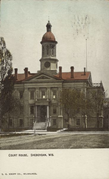 Text on front reads: " Court House, Sheboygan, Wis." Built in 1868 of grey brick, the court house was replaced in 1933.<p>The reverse of the postcard is an advertisement for the "Johnson Service Company." The text reads: "EVERY YEAR, EVERY WEEK, EVERY DAY. Shows an increased use of the Johnson System of Temperature Regulation. We have sent you a card each week for a year. We shall send one each week for FIFTY years. Johnson Service Co."