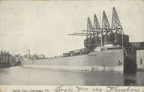 Text on front reads: "Harbor View - Sheboygan, Wis." A lake freighter, or "laker" is docked at the harbor.