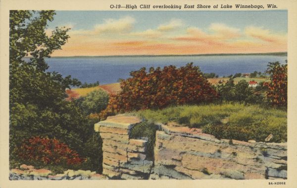Caption reads: "High Cliff overlooking East Shore of Lake Winnebago, Wis." Elevated view of Lake Winnebago from High Cliff State Park. A stone outcropping is in the foreground. Small buildings are beyond the outcropping on the right towards the lake.