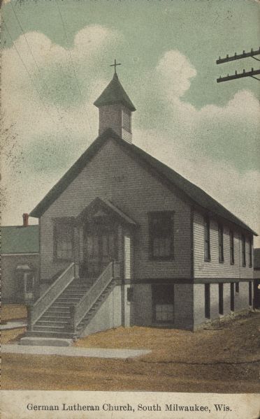Text on front reads: "German Lutheran Church, South Milwaukee, Wis." A clapboard Lutheran church with a belfry.