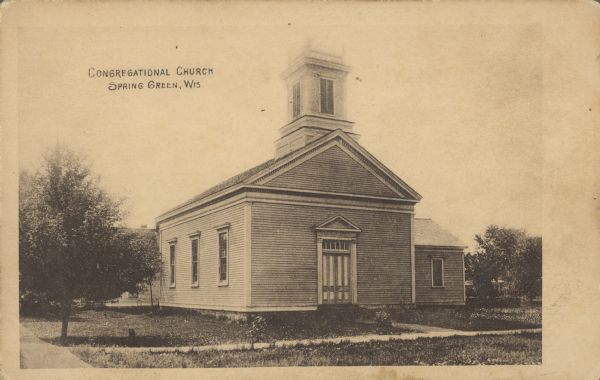 Text on front reads: "Congregational Church, Spring Green, Wis." The clapboard church was built in the Greek Revival style in 1868. Trees, a lawn and shrubs surround the building. Additions were built in 1904, 1922 and 1944.