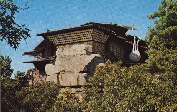 Text on the reverse reads: "The House on the Rock, at Spring Green, Wisconsin, on Highway 23, North of Dodgeville, Wisconsin. Access to this rock is through a winding ramp; from the top it affords a beautiful view of the hills and valleys surrounding the Wisconsin River." A 14 room house built on a formation named Deer Shelter Rock by Alex Jordan during the 1940s. It was originally a weekend retreat, but grew to be much more.