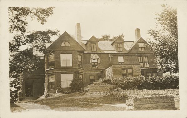 The first building built for the Hillside Home School, 4 miles from Spring Green. Exterior view of the Hillside Home Building, a shingle style building, designed by Frank Lloyd Wright in 1887 for his aunts, Jane and Ellen Lloyd Jones. It was used as a dormitory and library. Wright had the building demolished in 1950.
