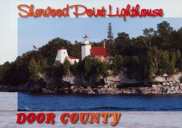 Text on front reads: "Sherwood Point Lighthouse, Door County." On reverse: "Built in 1883, the Sherwood Point Lighthouse marks the entrance into Sturgeon Bay from Green Bay. Today it is used as a private residence by the Coast Guard." The lighthouse was built of red brick and had the distinction of being the first manned light on the Great Lakes. It was automated in 1983.