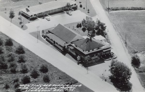 Text on front reads: "Nightingale Supper Club and Lorraine Supper Club, Sturgeon Bay, Wis." Aerial view of the two businesses on State Highway Business 42, in northern Sturgeon Bay. The supper club is still serving today.