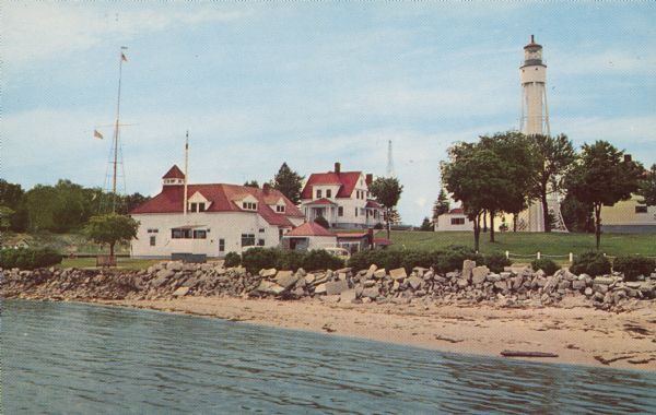 Text on reverse reads: "Coast Guard Station and Light House at Sturgeon Bay Ship Canal, Door County, Wisconsin." The lighthouse was completed in 1898 but some additional support was needed before it saw light in 1899. The Coast Guard took control of the country's lighthouses in 1939. It was automated in 1972. The site remains an active U.S. Coast Guard Station to this day.