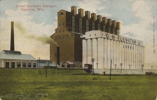 Text on front reads: "Great Northern Elevator, Superior, Wis." The steel and reinforced concrete grain elevator was built by the Great Northern Railroad in Superior in 1898. At the time it was the largest grain elevator in the world and is still in use today.