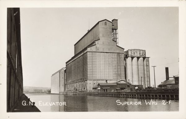 Text on front reads: "G.N. Elevator, Superior, Wis." The steel and reinforced concrete grain elevator was built by the Great Northern Railroad in Superior in 1898. At the time it was the largest grain elevator in the world and is still in use today.