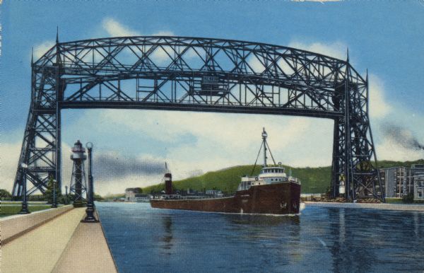 Text on reverse reads: "G-1–Ore Boat Leaving Duluth-Superior Harbor, Lift Bridge Raised. Giant lake freighters leave Duluth-Superior Harbor, the world's largest fresh-water port, and pass beneath Duluth's 'trade-mark,' the Aerial Lift Bridge spanning the entrance to the ship canal. The navigation season extends approximately from April 15th to December 15th, or eight months, to make the harbor second to that of New York in annual shipping tonnage which consists mainly of iron ore, coal, grain and cement." A steamship entering the harbor under the Aerial Lift Bridge, completed in 1905. It was remodeled and reopened in 1930. A row of lampposts light the pier, with a beacon or lighthouse in the distance. Buildings are on the right with hills in the background. 