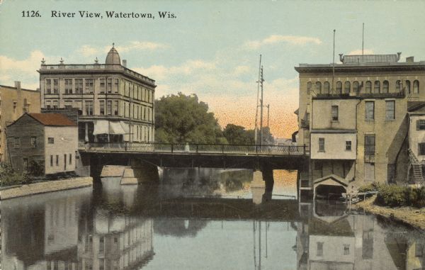Text on front reads: "River View, Watertown, Wis." The Main Street bridge over the Rock River, with large buildings on both sides.