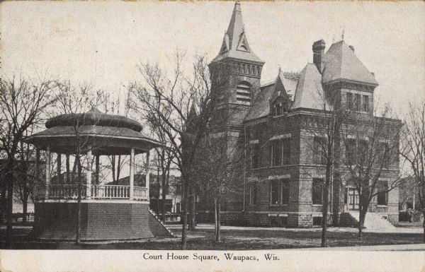 Text on front reads: "Court House Square, Waupaca, Wis." The courthouse was built in 1882 of brick in the Neoclassical style. It was razed in in the early 1990s. The wood shingle, Queen Anne style bandstand was constructed in 1898 for $275.00. It was going to be torn down after the court house was razed, but the citizens of Wauapaca objected. It was remodeled in 1997 and lowered 3 feet. Bands still perform there today.

