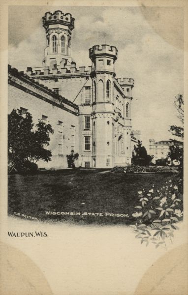 Text on front reads: "Wisconsin State Prison, Waupun, Wis." Gothic Revival buildings at the prison, built in 1854 of limestone, with ornate towers. A lawn, trees and a garden are in the foreground. The prison housed adult men and women until 1933, when a separate women's prison was built.