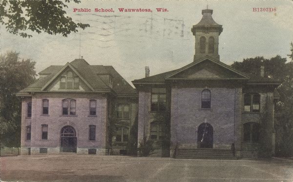 Text on front reads: "Public School, Wauwatosa, Wis." The building on the right was the original school, the building on the left was added later. The buildings have arched doors, windows and a belfry. A large playground is in the foreground.