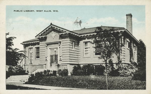 Text on front reads: "Public Library, West Allis, Wis." Built in 1914 of brick in the Neoclassical style, the construction was supported by a gift of $15,000.00 from the Carnegie Foundation. It is now an apartment building.