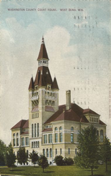 Text on front reads: "Washington County Court House, West Bend, Wis." On reverse: "We have previously sent you cards showing the extensive use of the Johnson System of Temperature Regulation in the United States Government Blgs. and State Capitols. We now send you a series or cards, one each weekly, showing the Extensive use of this System of Temperature Regulation in Court Houses and City Halls. Johnson Service Company." Built in 1889 of Cream Brick in the Richardson Romanesque style. Surrounded by trees and and a lawn. It is listed on the State and National Register of Historic Places.
