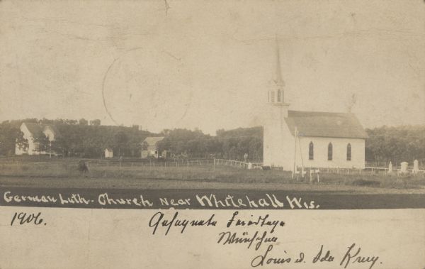 Text on front reads: "German Luth. Church near Whitehall, Wis." The church building on the right is surrounded by a farm, trees, fields and fences.